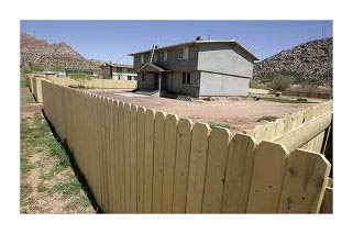 Wood fence around polygamous compound